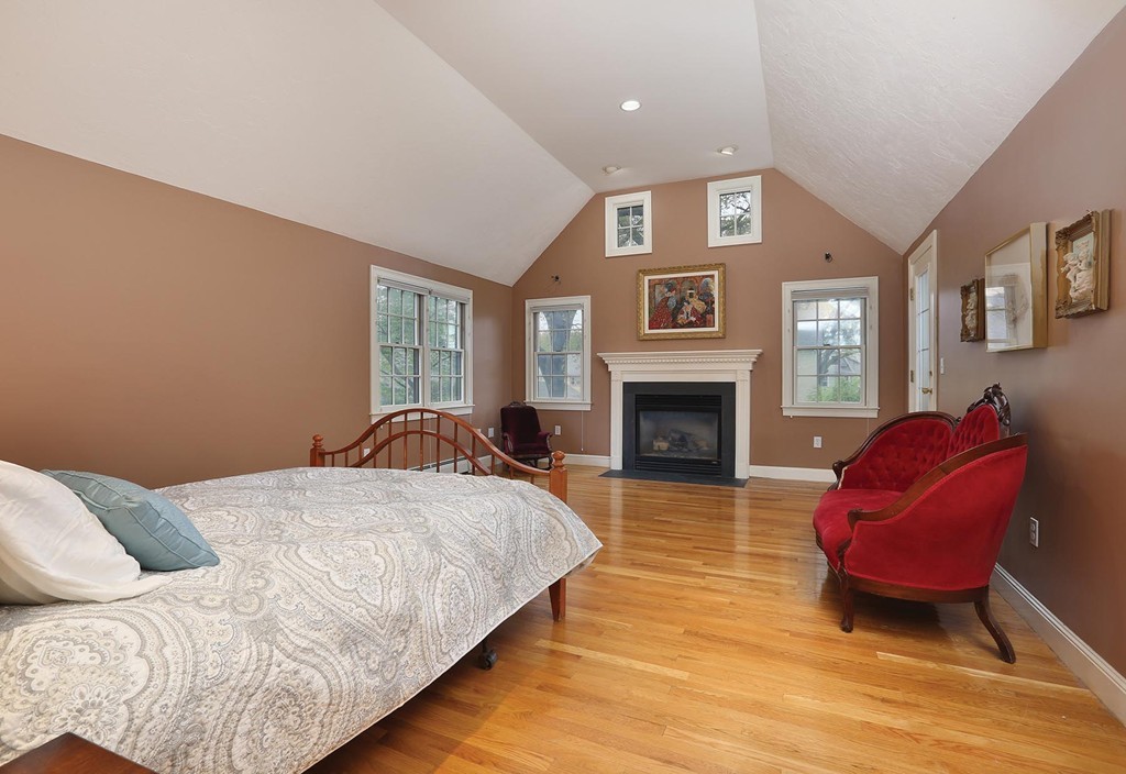 26 Rowena Road Newton, MA 02459 - Photo 5 of 9 a spacious bedroom with a bed and a fireplace