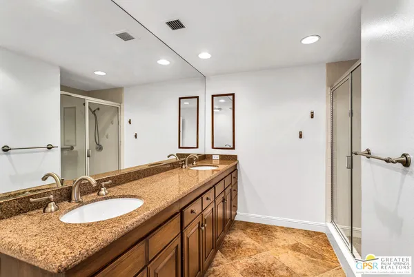 a bathroom with a sink double vanity and a mirror
