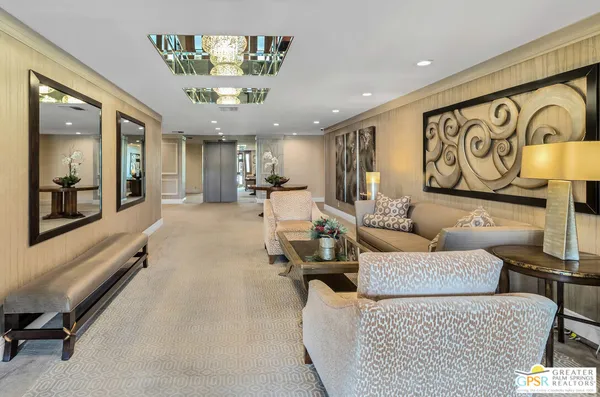 a living room with furniture and a large mirror