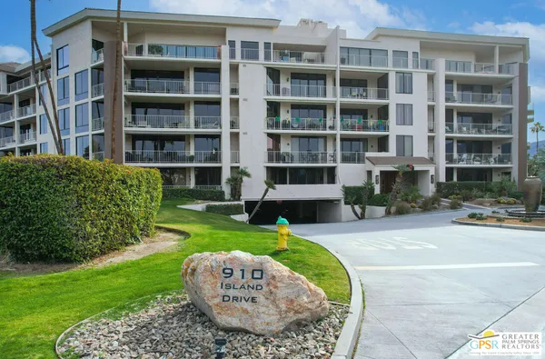 a view of a house with a yard fire pit and outdoor seating