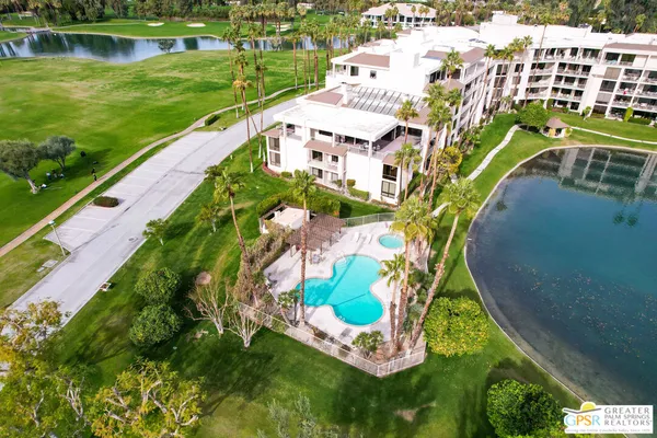 an aerial view of a house with a garden and lake view