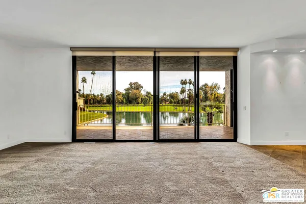 a view of an empty room with large windows