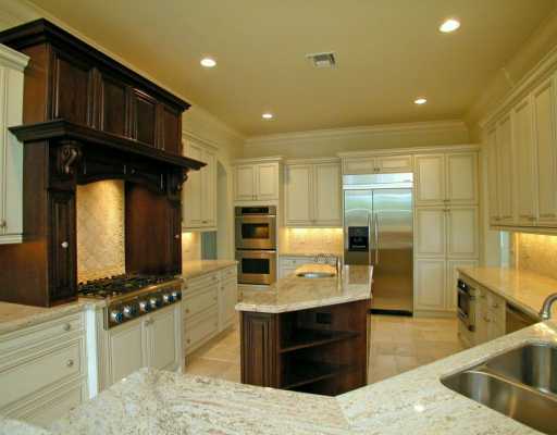 335 Northeast 4th Street Boca Raton, FL 33432 - Photo 7 of 16 a kitchen with stainless steel appliances kitchen island granite countertop a sink and cabinets