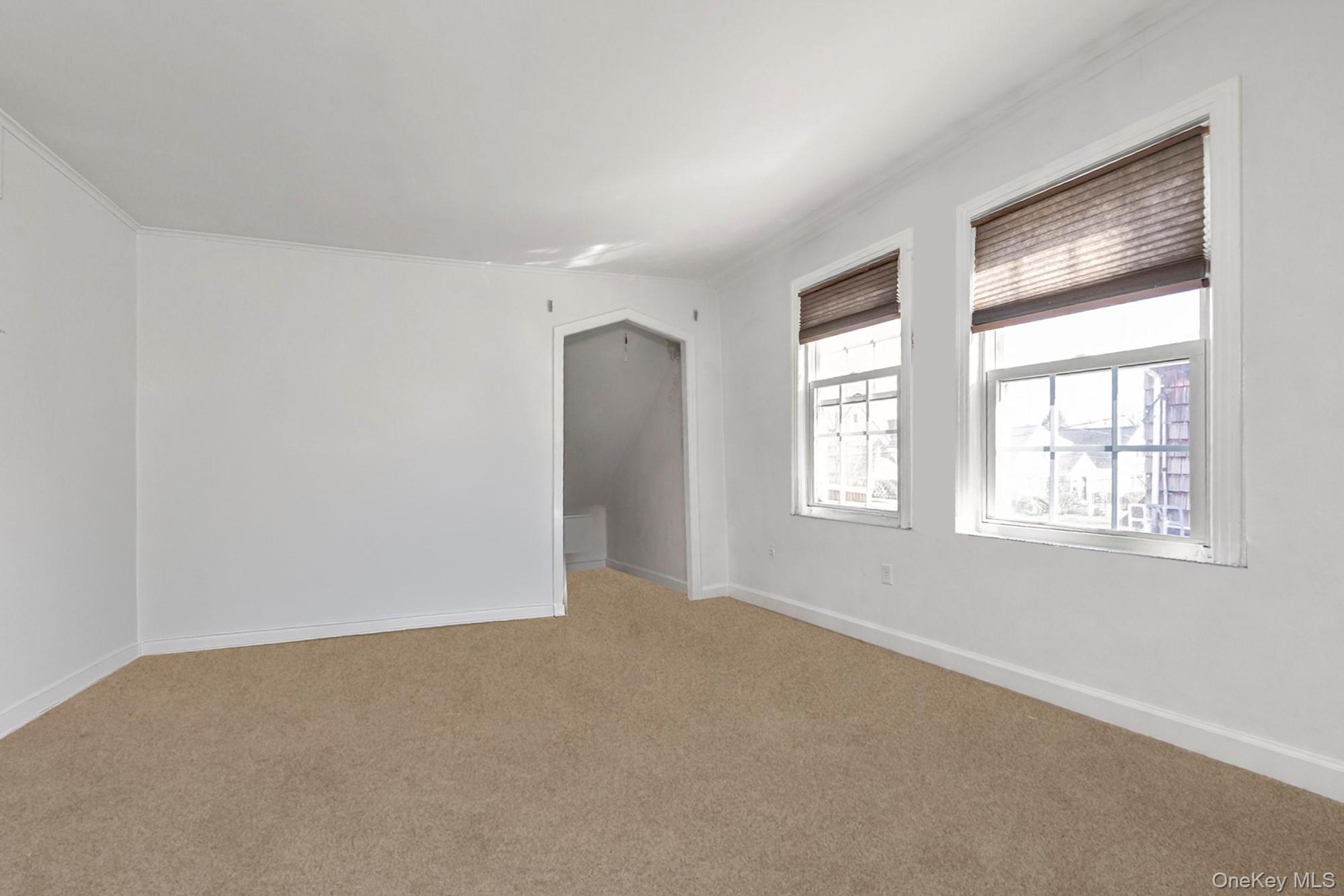 81 Stuart Street Lynbrook, NY 11563 - Photo 14 of 23 a view of an empty room with a window