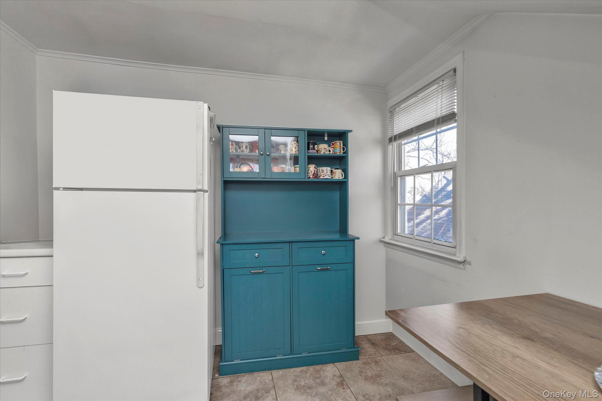 81 Stuart Street Lynbrook, NY 11563 - Photo 16 of 23 a view of kitchen with window and refrigerator