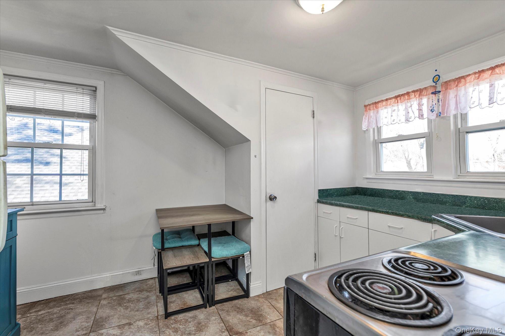 81 Stuart Street Lynbrook, NY 11563 - Photo 17 of 23 a kitchen with a stove and a window