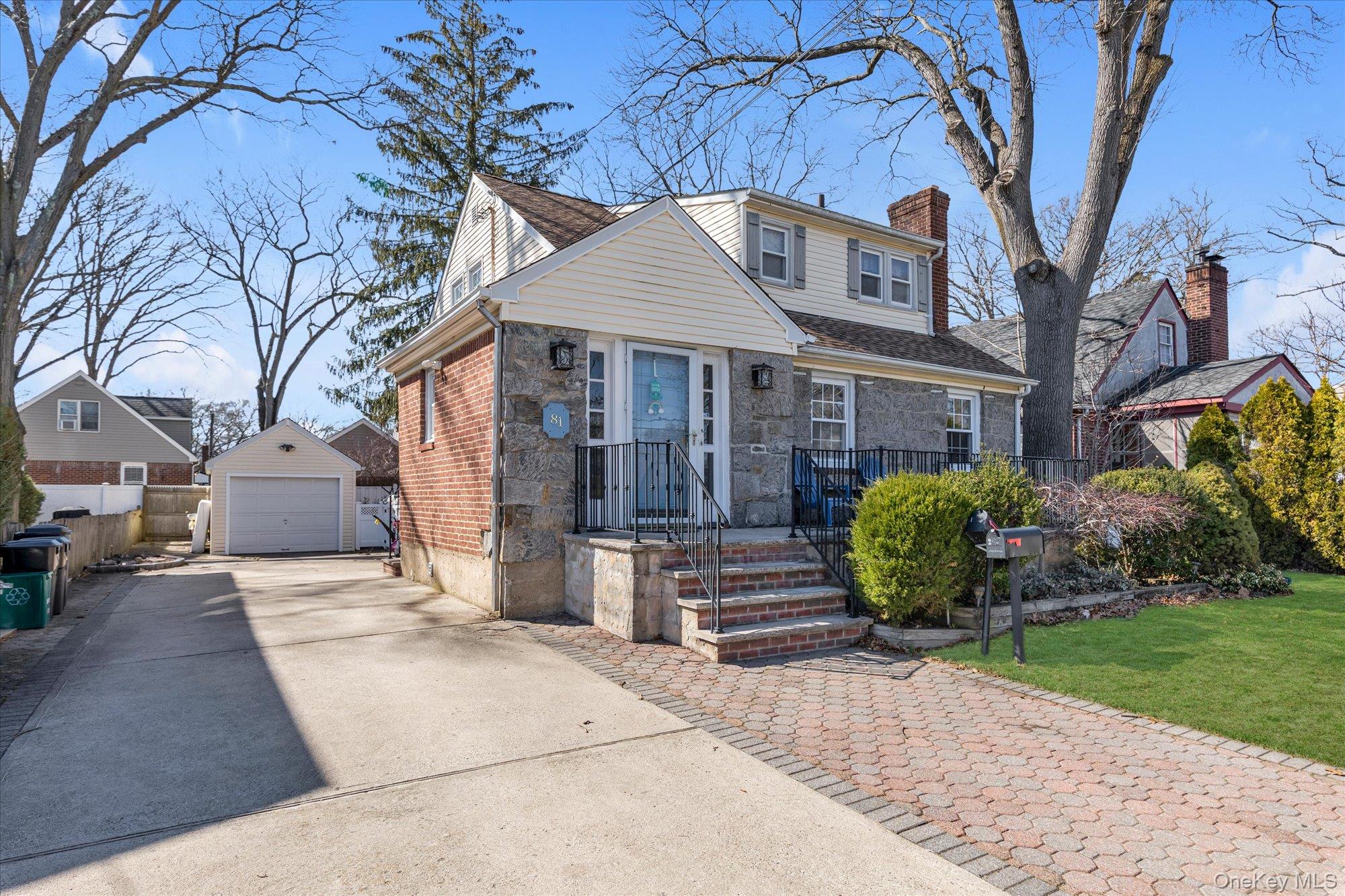 81 Stuart Street Lynbrook, NY 11563 - Photo 22 of 23 a front view of a house with garden
