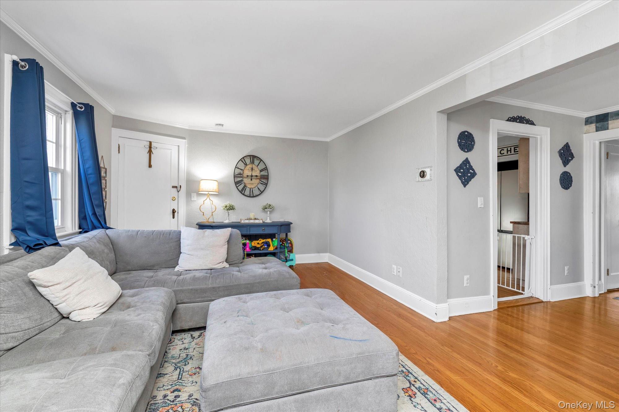 81 Stuart Street Lynbrook, NY 11563 - Photo 3 of 23 a living room with furniture and wooden floor