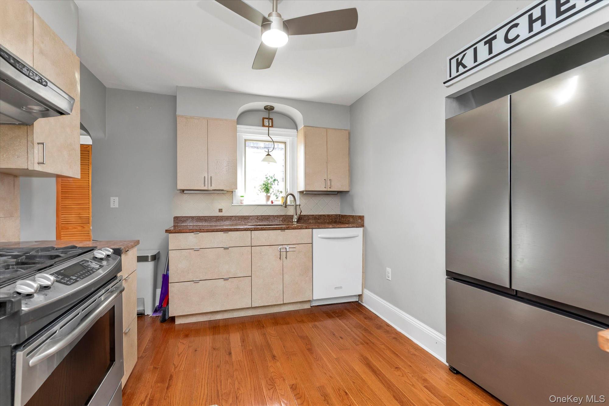 81 Stuart Street Lynbrook, NY 11563 - Photo 7 of 23 a kitchen with a stove and a refrigerator