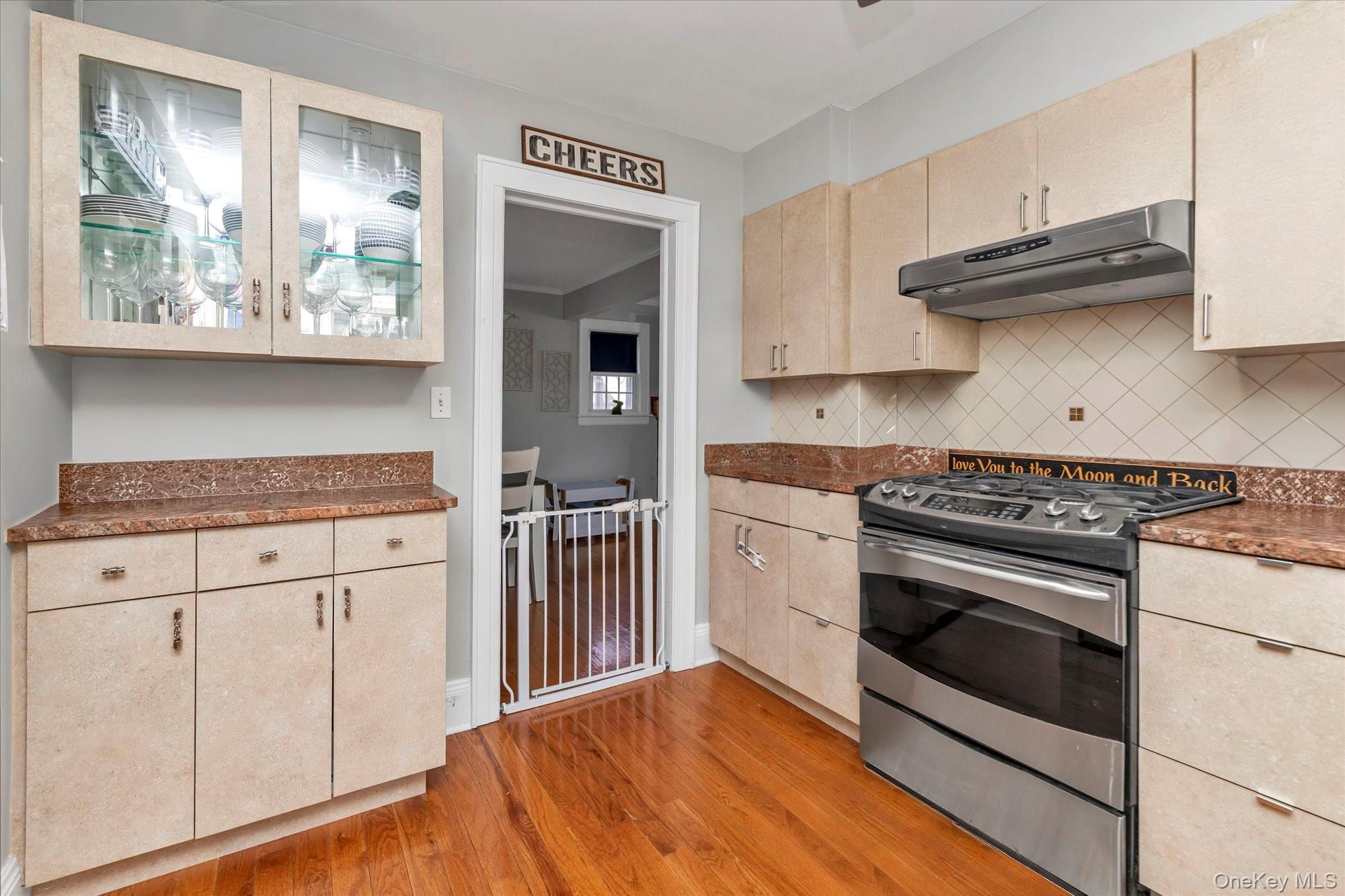 81 Stuart Street Lynbrook, NY 11563 - Photo 8 of 23 a kitchen with granite countertop a sink and a stove