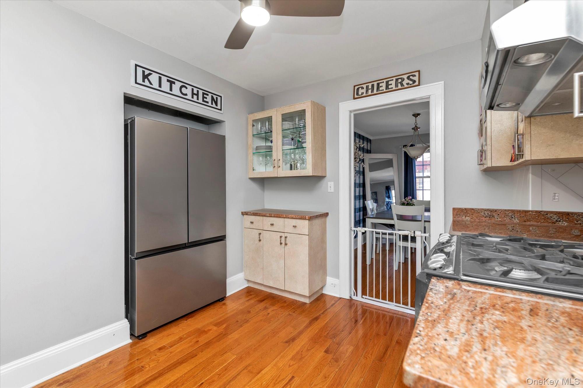 81 Stuart Street Lynbrook, NY 11563 - Photo 9 of 23 a kitchen with granite countertop a refrigerator and a stove top oven