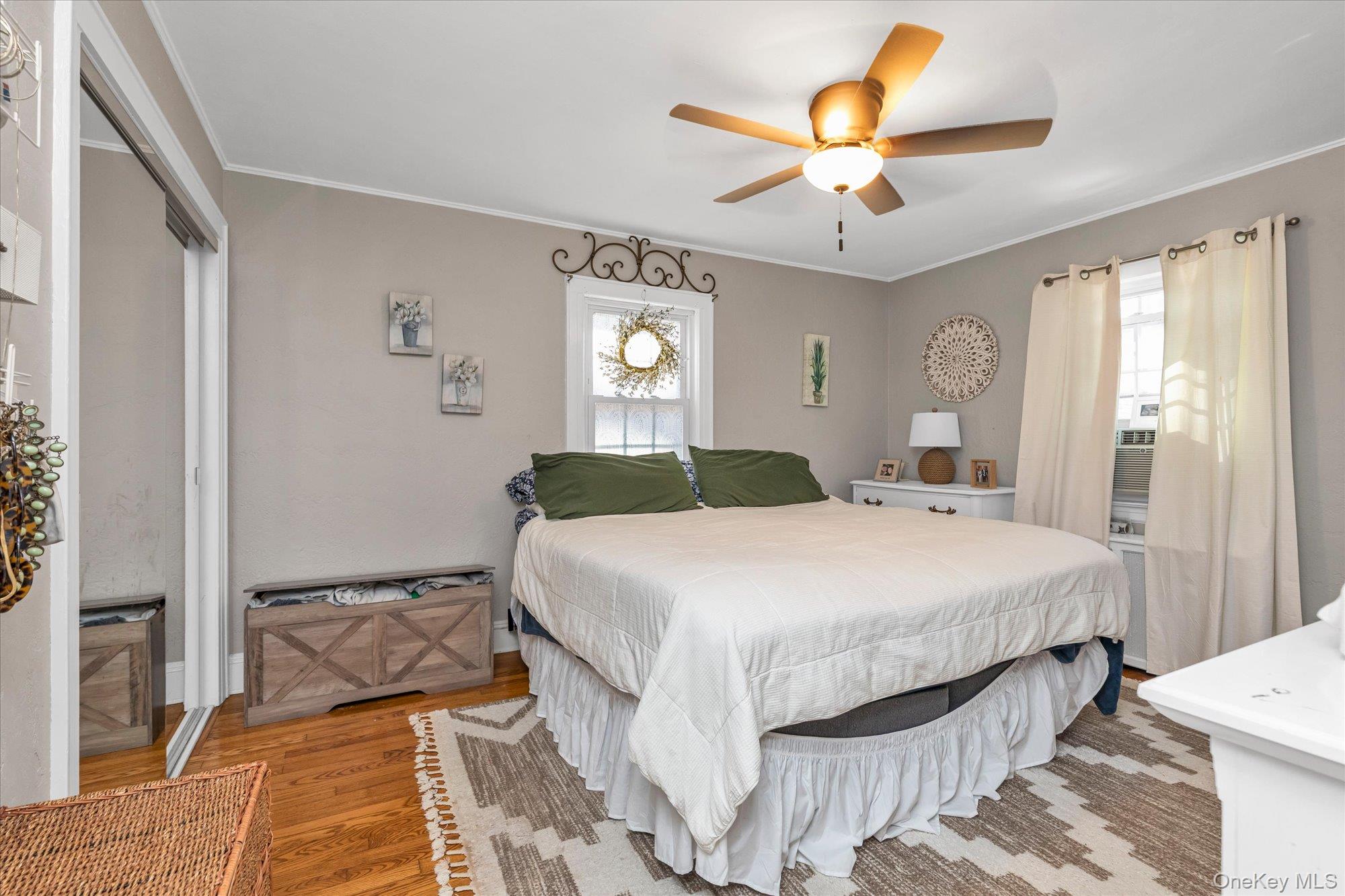 81 Stuart Street Lynbrook, NY 11563 - Photo 10 of 23 a bedroom with a bed and a chandelier