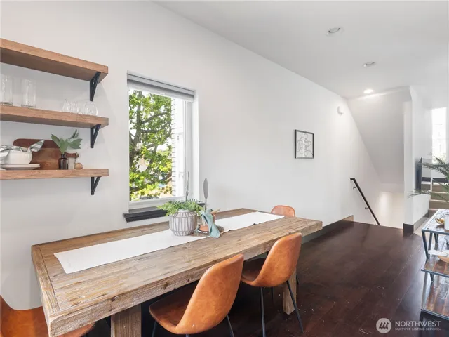 a room with a table chairs and a wooden floor