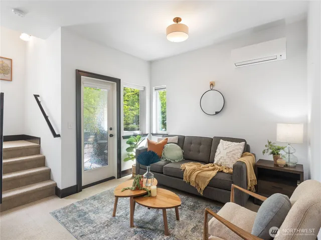 a living room with furniture and wooden floor