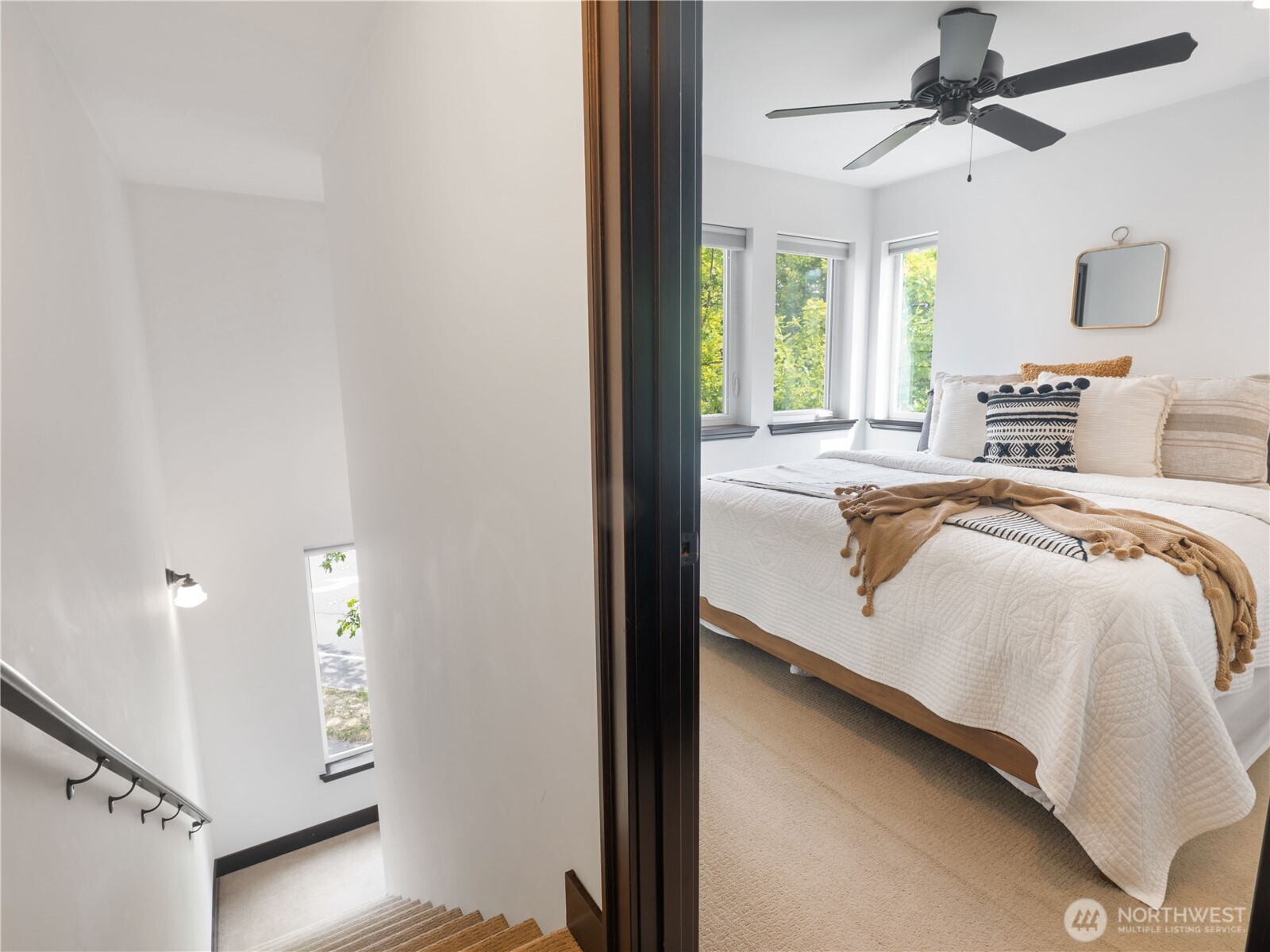 2019 Cornwall Avenue Bellingham, WA 98225 - Photo 21 of 40 a bedroom with a bed and a chandelier