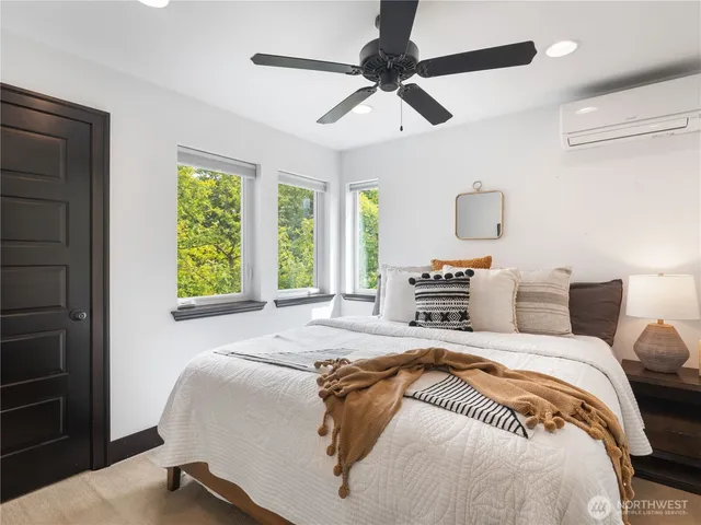 a bedroom with a large bed and a window