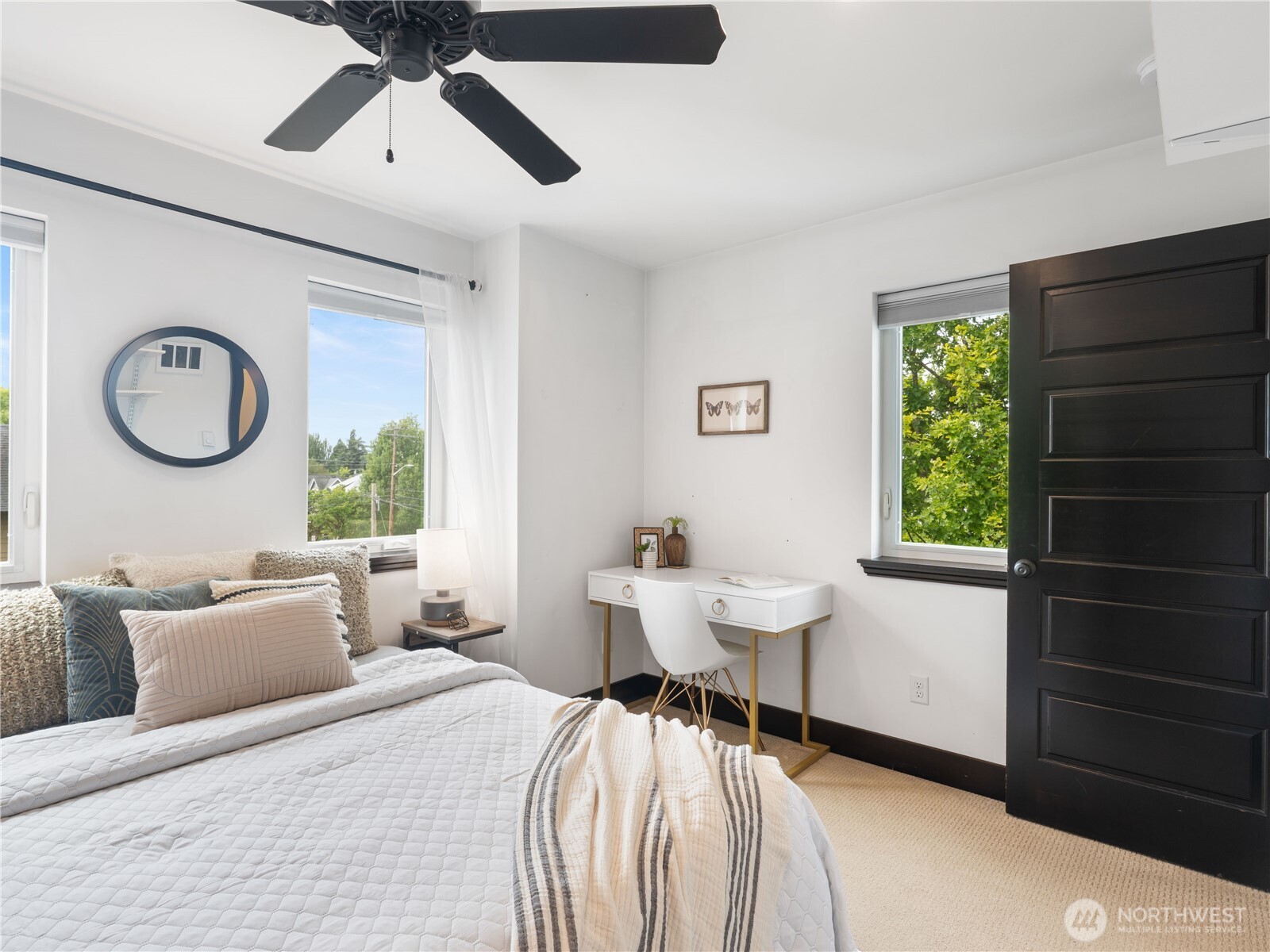 2019 Cornwall Avenue Bellingham, WA 98225 - Photo 27 of 40 a bedroom with a bed and a chandelier