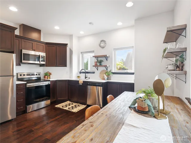 a kitchen with a sink appliances and cabinets