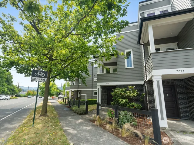 a view of a house with a tree in front of it