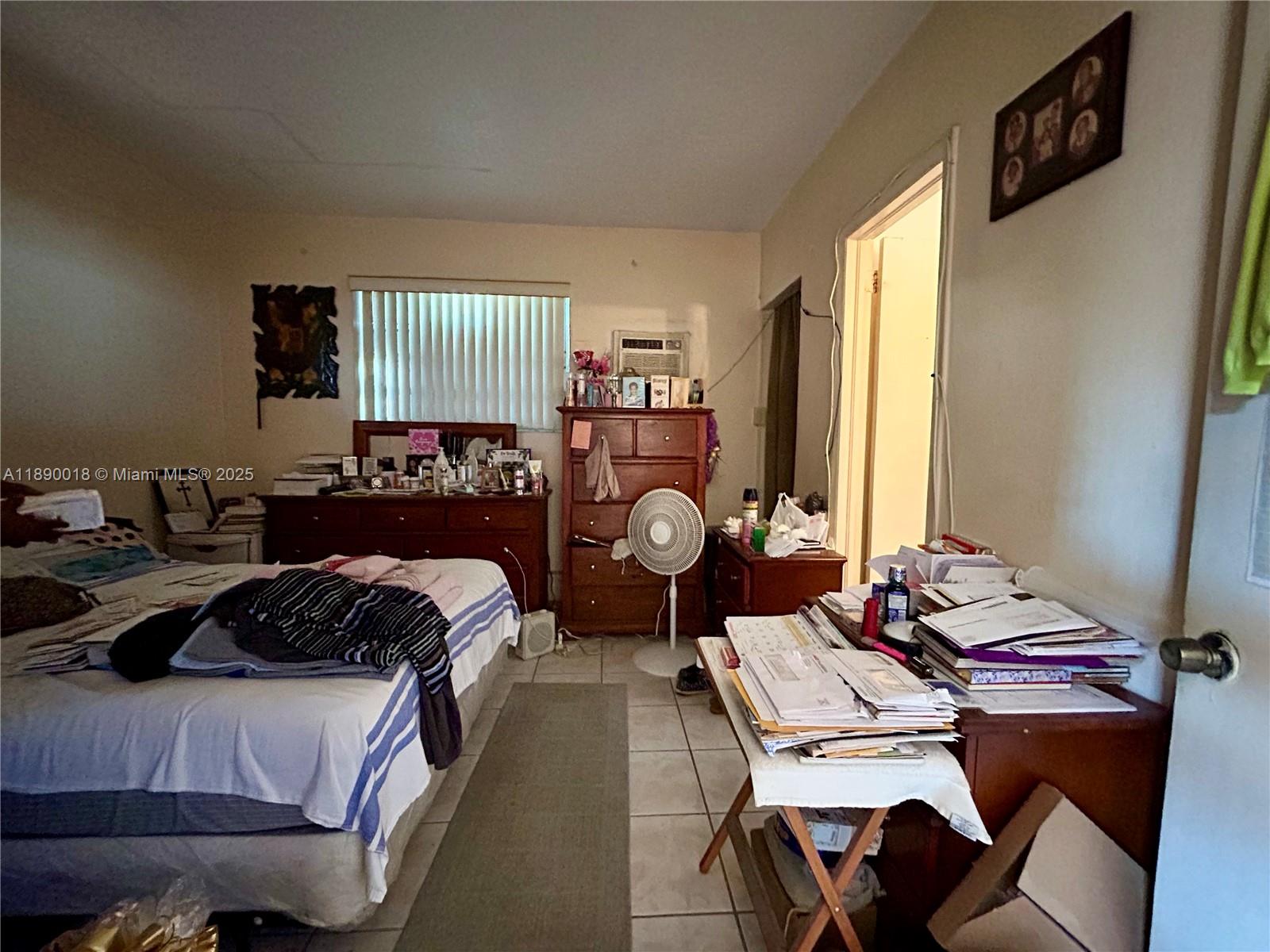 2013 Washington Avenue Opa-Locka, FL 33054 - Photo 17 of 19 a bedroom with a bed and a table