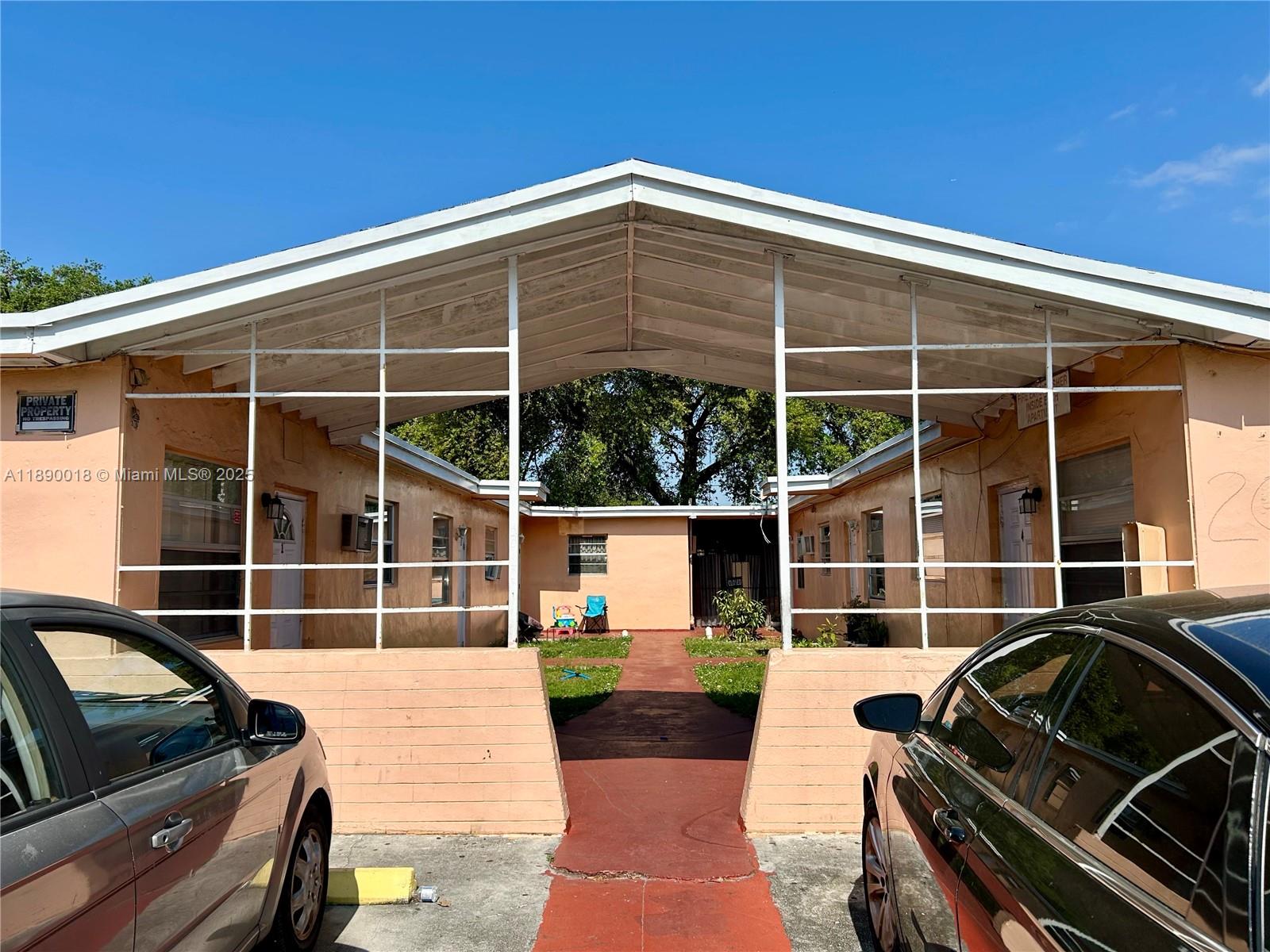 2013 Washington Avenue Opa-Locka, FL 33054 - Photo 4 of 19 a view of a roof deck with wooden floor and fence