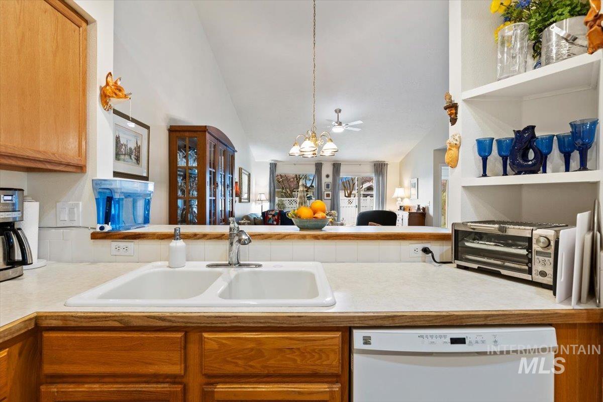 3357 West Fieldstream Lane Meridian, ID 83646 - Photo 12 of 24 Kitchen with light countertops, dishwasher, hanging lights, and lofted ceiling