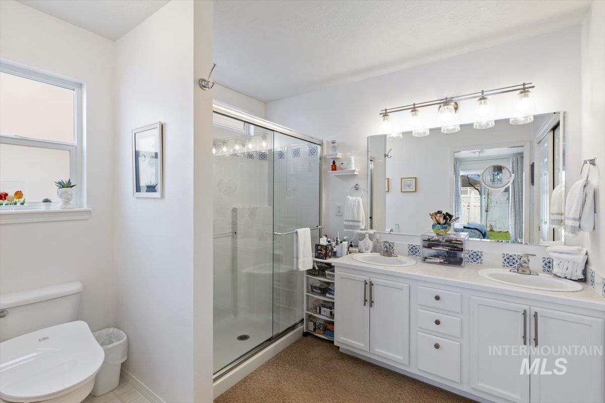 3357 West Fieldstream Lane Meridian, ID 83646 - Photo 17 of 24 Bathroom with double vanity and a shower stall