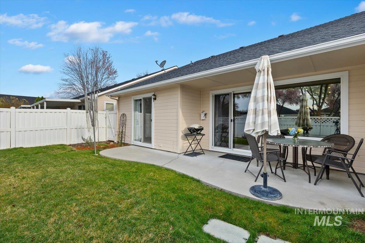 3357 West Fieldstream Lane Meridian, ID 83646 - Photo 23 of 24 Back of property with a patio, outdoor dining space, and a shingled roof