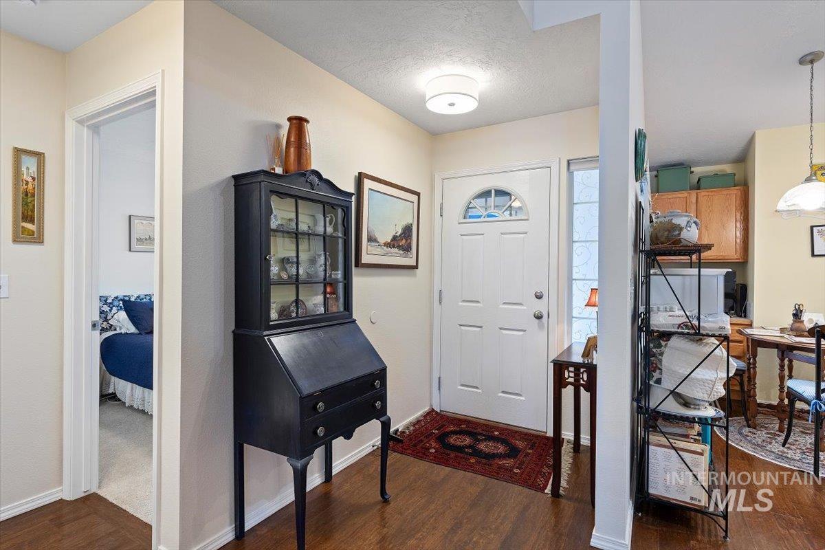 3357 West Fieldstream Lane Meridian, ID 83646 - Photo 4 of 24 Foyer entrance featuring dark wood-type flooring and a textured ceiling