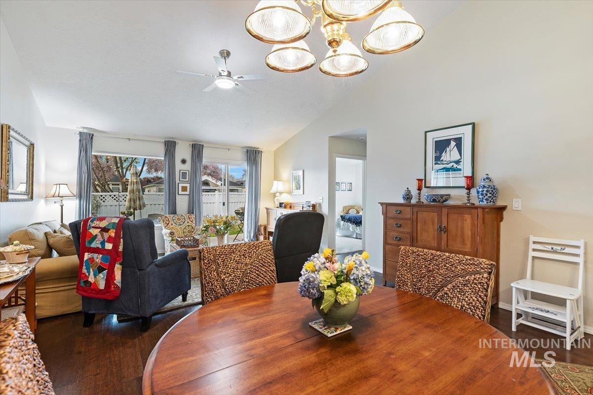 3357 West Fieldstream Lane Meridian, ID 83646 - Photo 7 of 24 Dining area with a ceiling fan, suspended lighting, dark wood-style floors, and vaulted ceiling