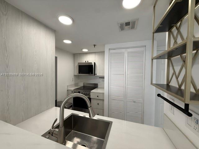 540 Brickell Key Drive, Unit 1024 Miami, FL 33131 - Photo 21 of 28 a view of a kitchen with a sink and dishwasher