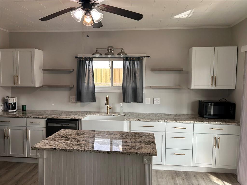230 Maple Street Everson, PA 15631 - Photo 17 of 32 a kitchen with granite countertop a sink stainless steel appliances and cabinets