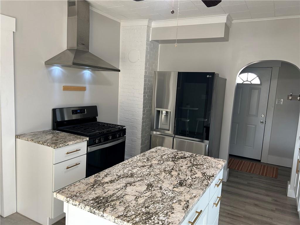 230 Maple Street Everson, PA 15631 - Photo 18 of 32 a kitchen with a stove and a wooden floor