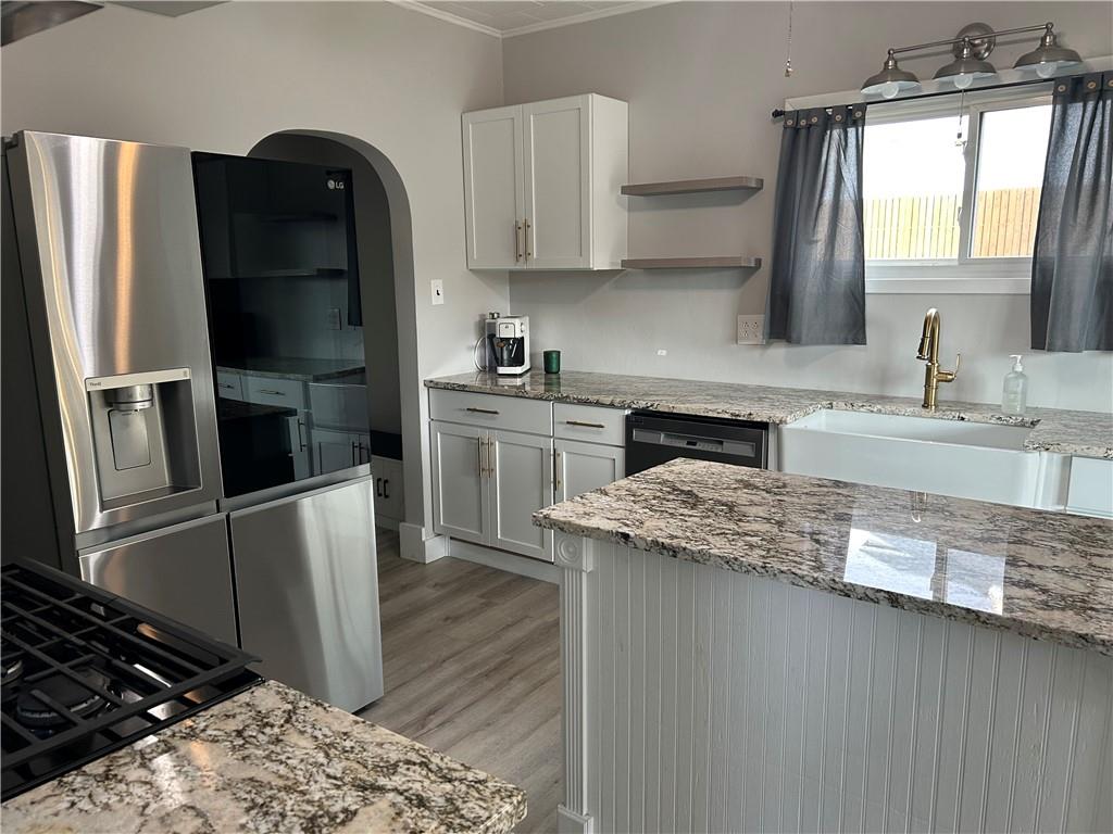 230 Maple Street Everson, PA 15631 - Photo 19 of 32 a kitchen with stainless steel appliances granite countertop a refrigerator a stove and a sink