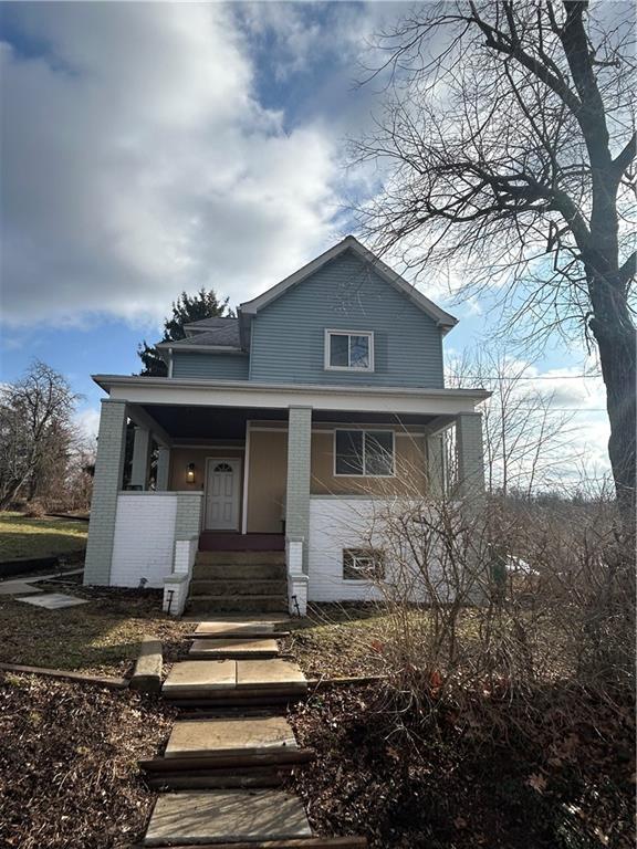 230 Maple Street Everson, PA 15631 - Photo 2 of 32 a front view of a house with a yard