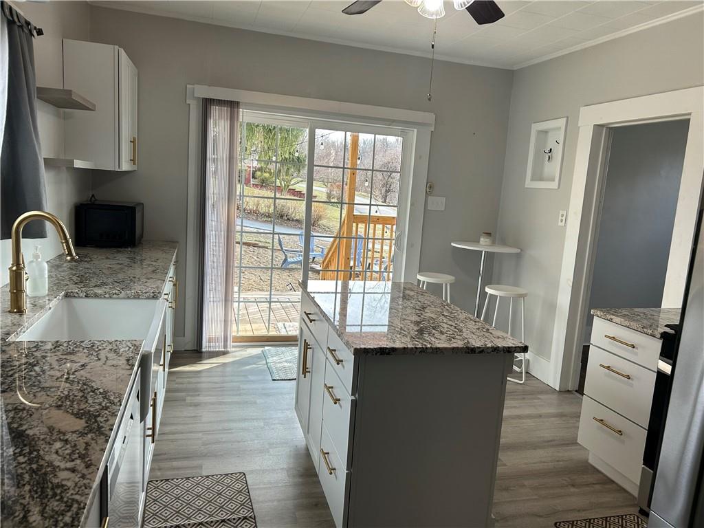 230 Maple Street Everson, PA 15631 - Photo 21 of 32 a kitchen with granite countertop a sink appliances and cabinets