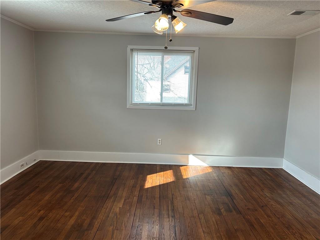 230 Maple Street Everson, PA 15631 - Photo 31 of 32 an empty room with wooden floor chandelier fan and windows