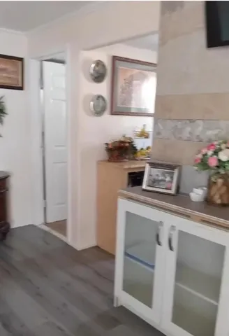 a kitchen with a stove and a wooden floor