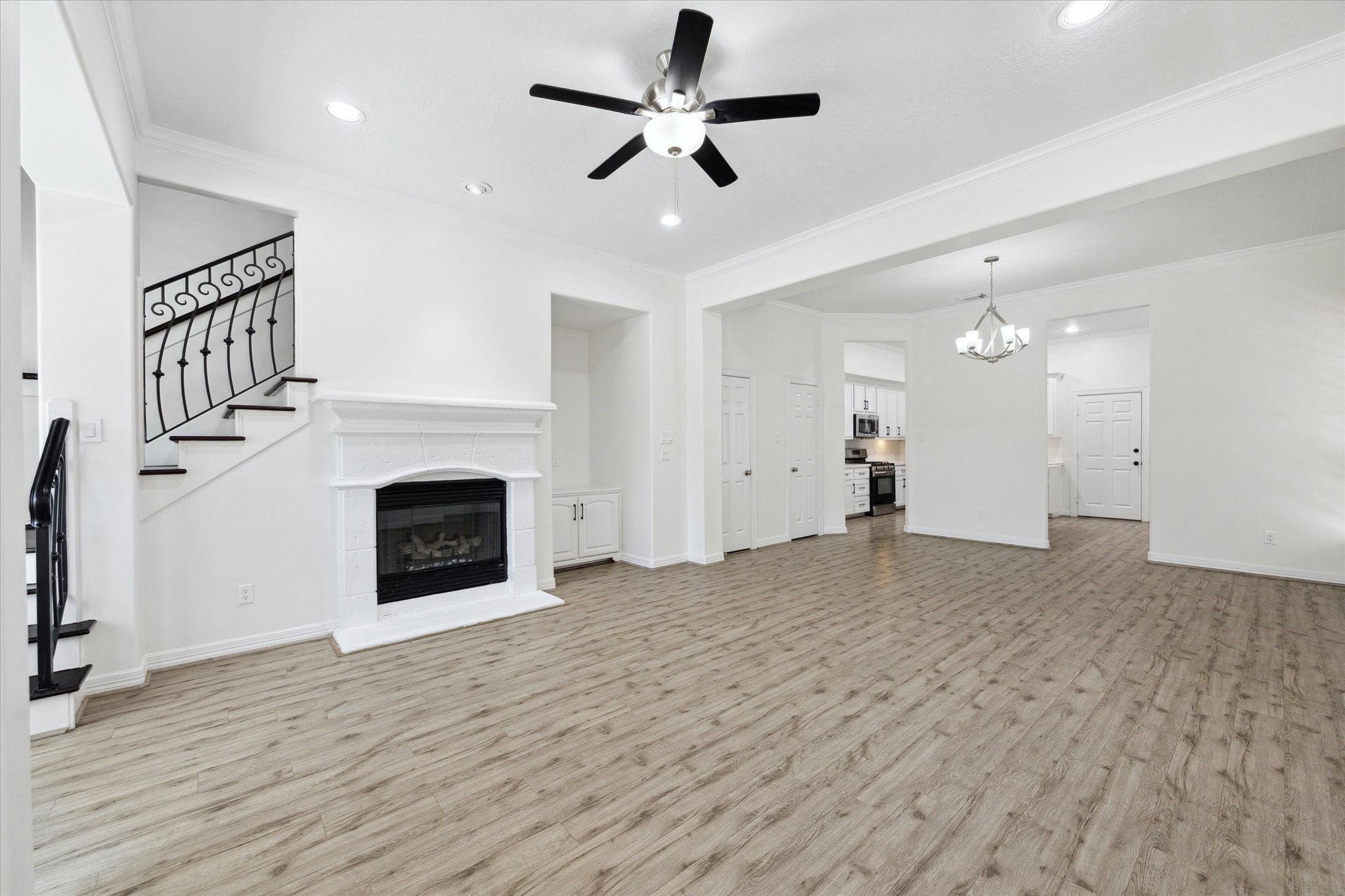 Bright living space on first floor. Ceiling fan, fireplace. Room leads into, dining room, kitchen and breakfast area.
