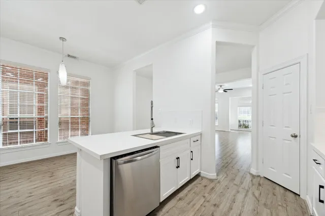 a kitchen with a sink stove and cabinets