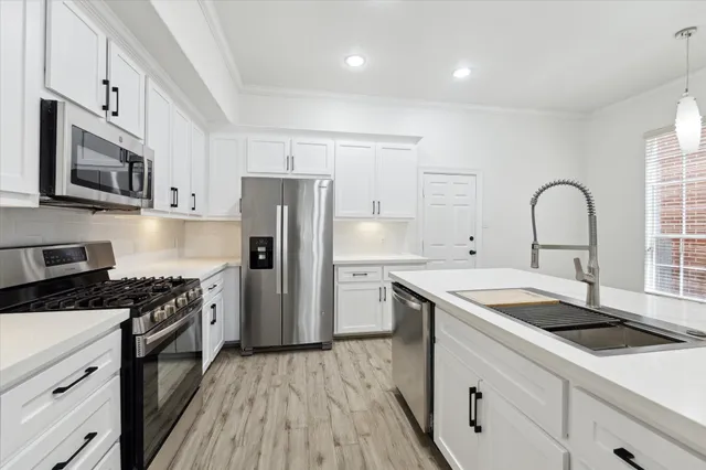 a kitchen with a sink stove and refrigerator