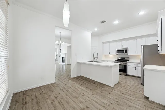 a kitchen with a refrigerator and a stove top oven