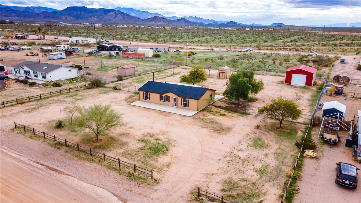 3248 West Carmichael Road Golden Valley, AZ 86413 - Photo 1 of 53 Aerial view of sparsely populated area with mountains
