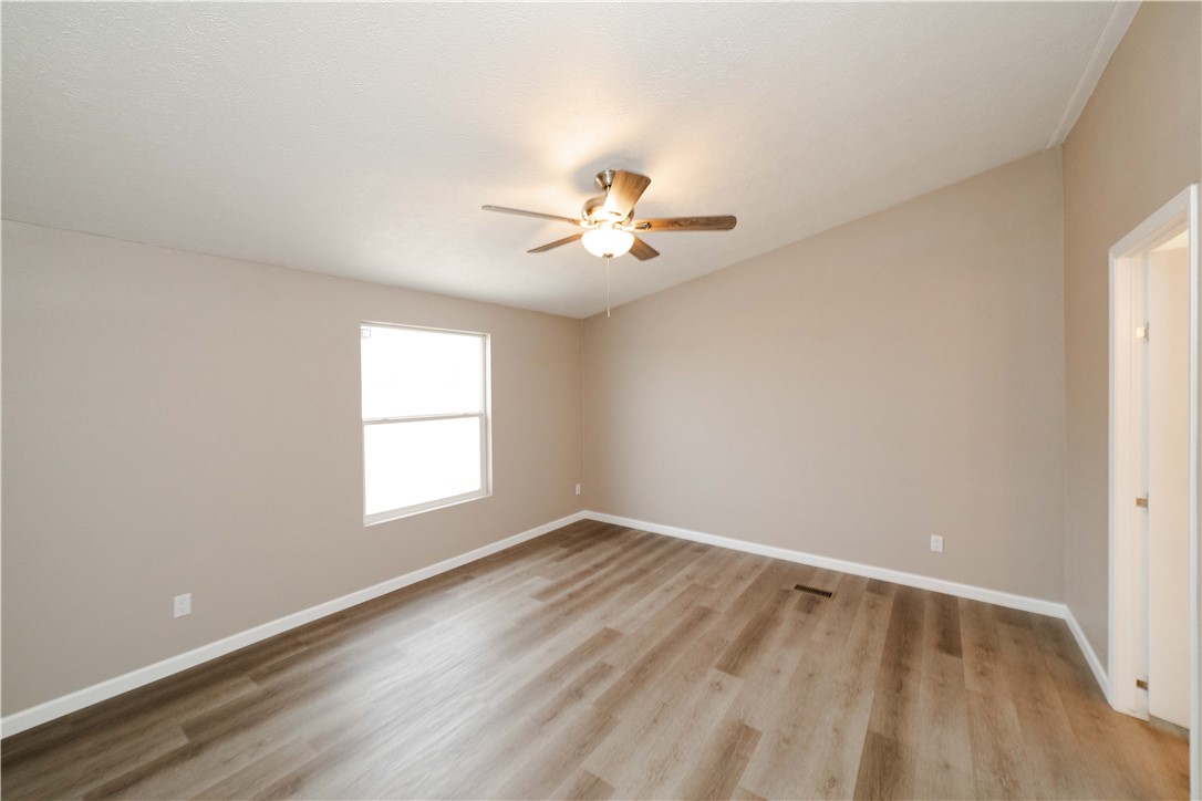 3248 West Carmichael Road Golden Valley, AZ 86413 - Photo 19 of 53 Spare room with light wood-style flooring and a ceiling fan