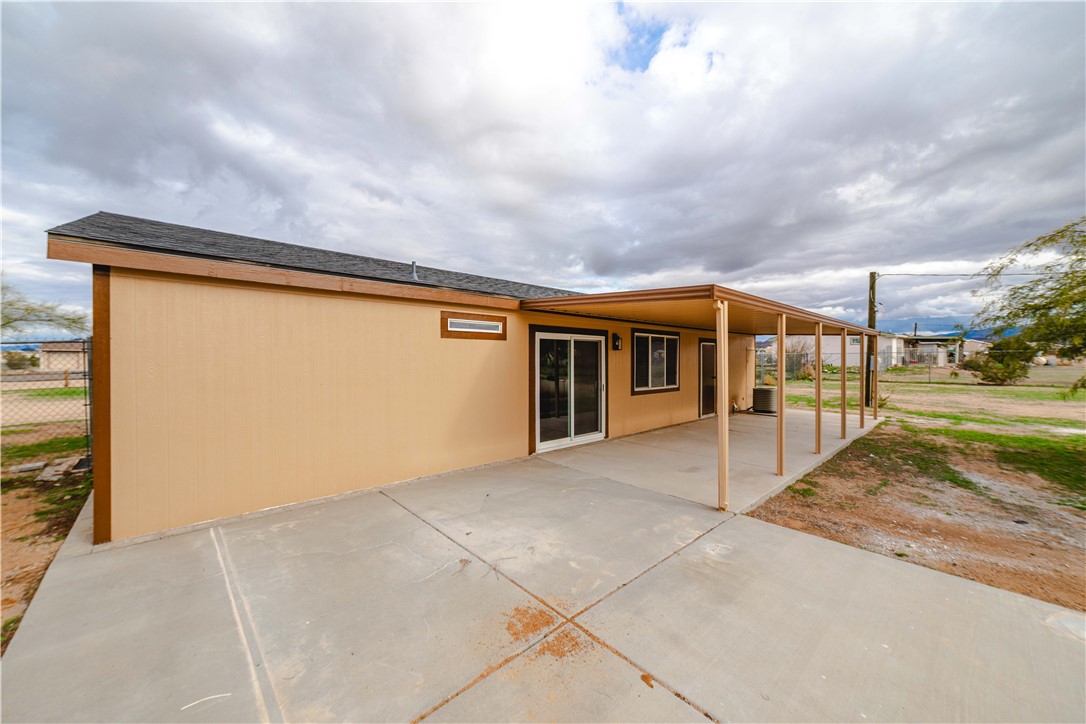 3248 West Carmichael Road Golden Valley, AZ 86413 - Photo 46 of 53 Rear view of house with a patio area