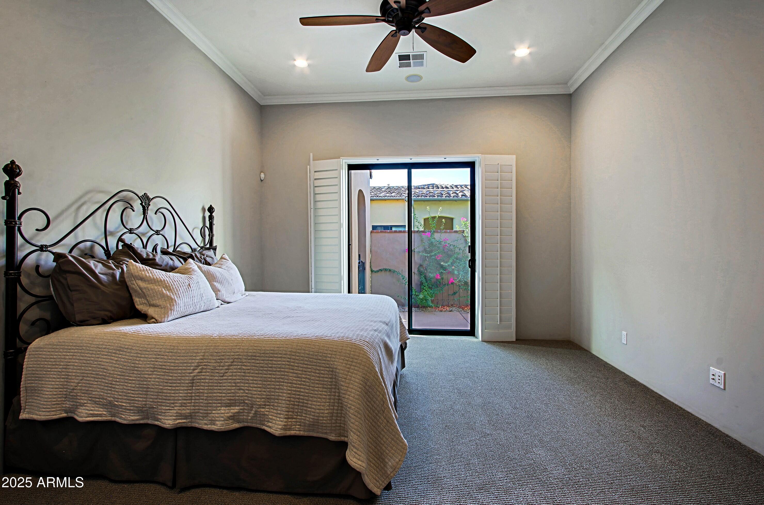 18650 North Thompson Peak Parkway, Unit 1052 Scottsdale, AZ 85255 - Photo 16 of 38 a bedroom with a large bed and a window