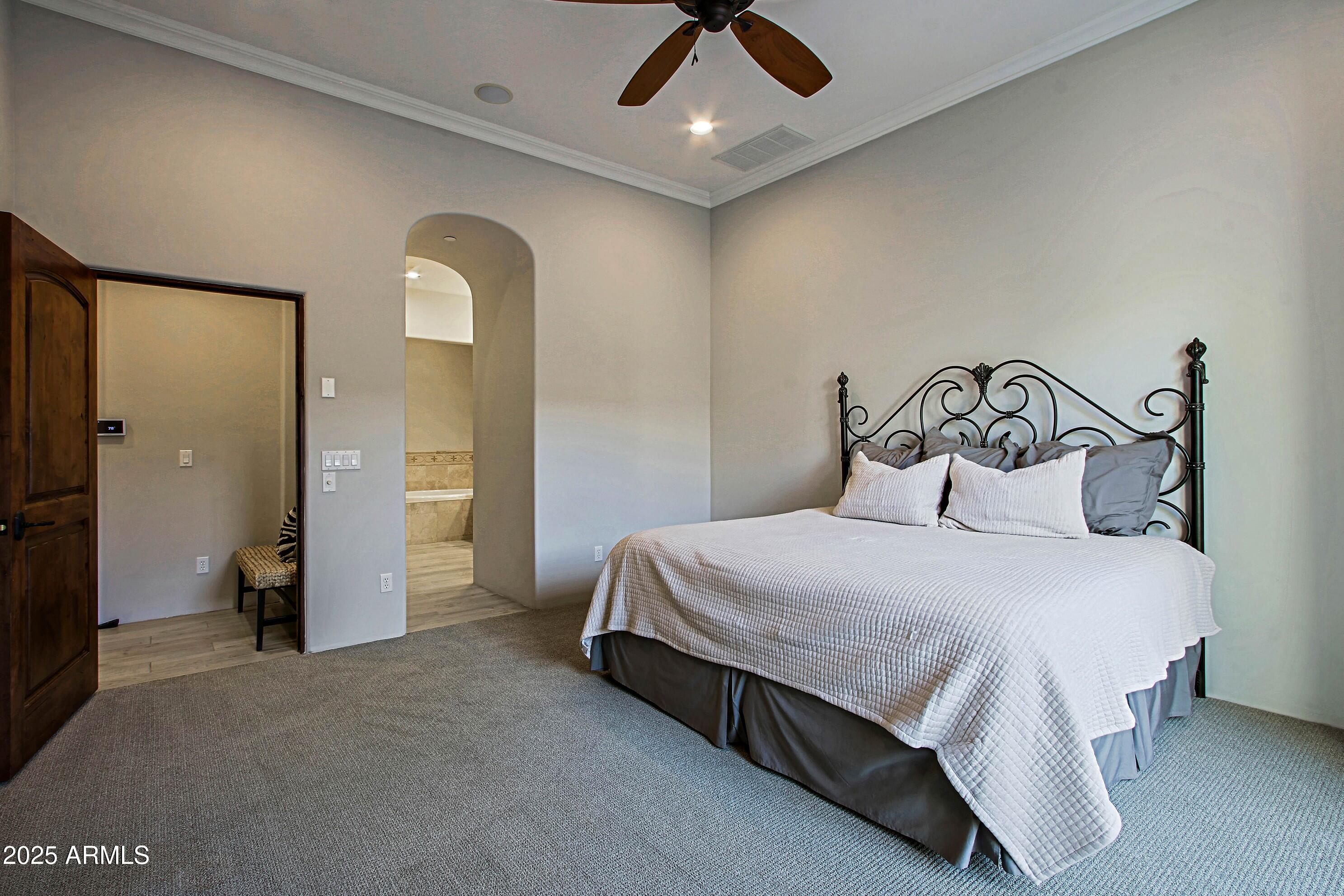 18650 North Thompson Peak Parkway, Unit 1052 Scottsdale, AZ 85255 - Photo 17 of 38 a spacious bedroom with a bed and ceiling fan