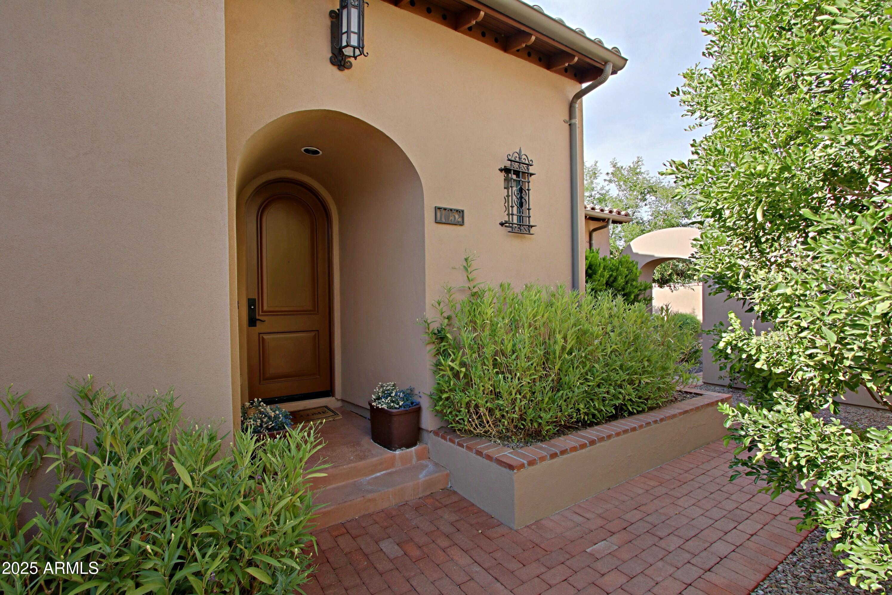 18650 North Thompson Peak Parkway, Unit 1052 Scottsdale, AZ 85255 - Photo 2 of 38 a front view of a house with garden