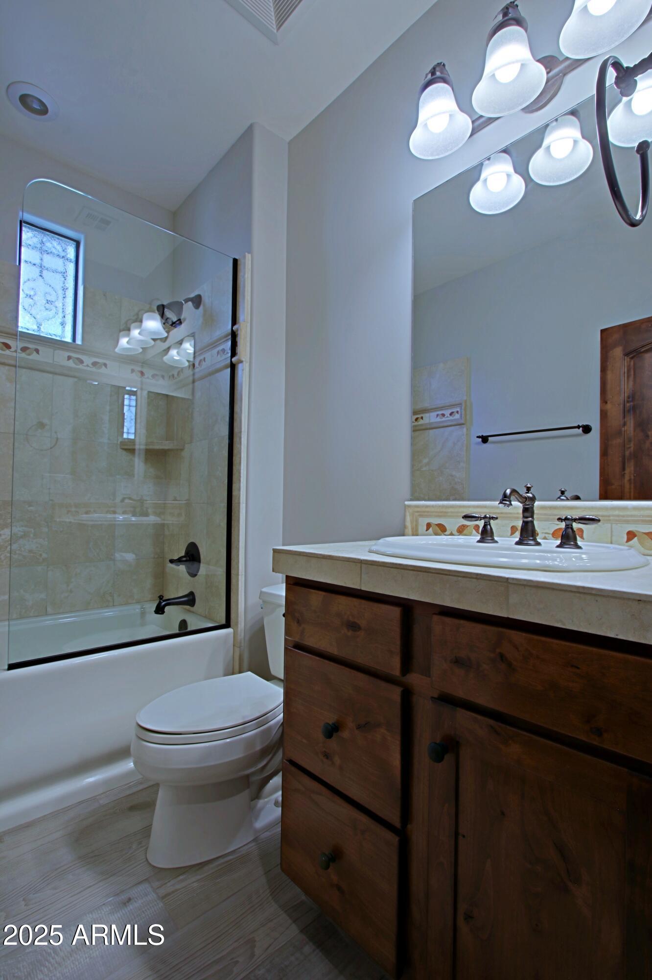 18650 North Thompson Peak Parkway, Unit 1052 Scottsdale, AZ 85255 - Photo 21 of 38 a bathroom with a sink a toilet and shower