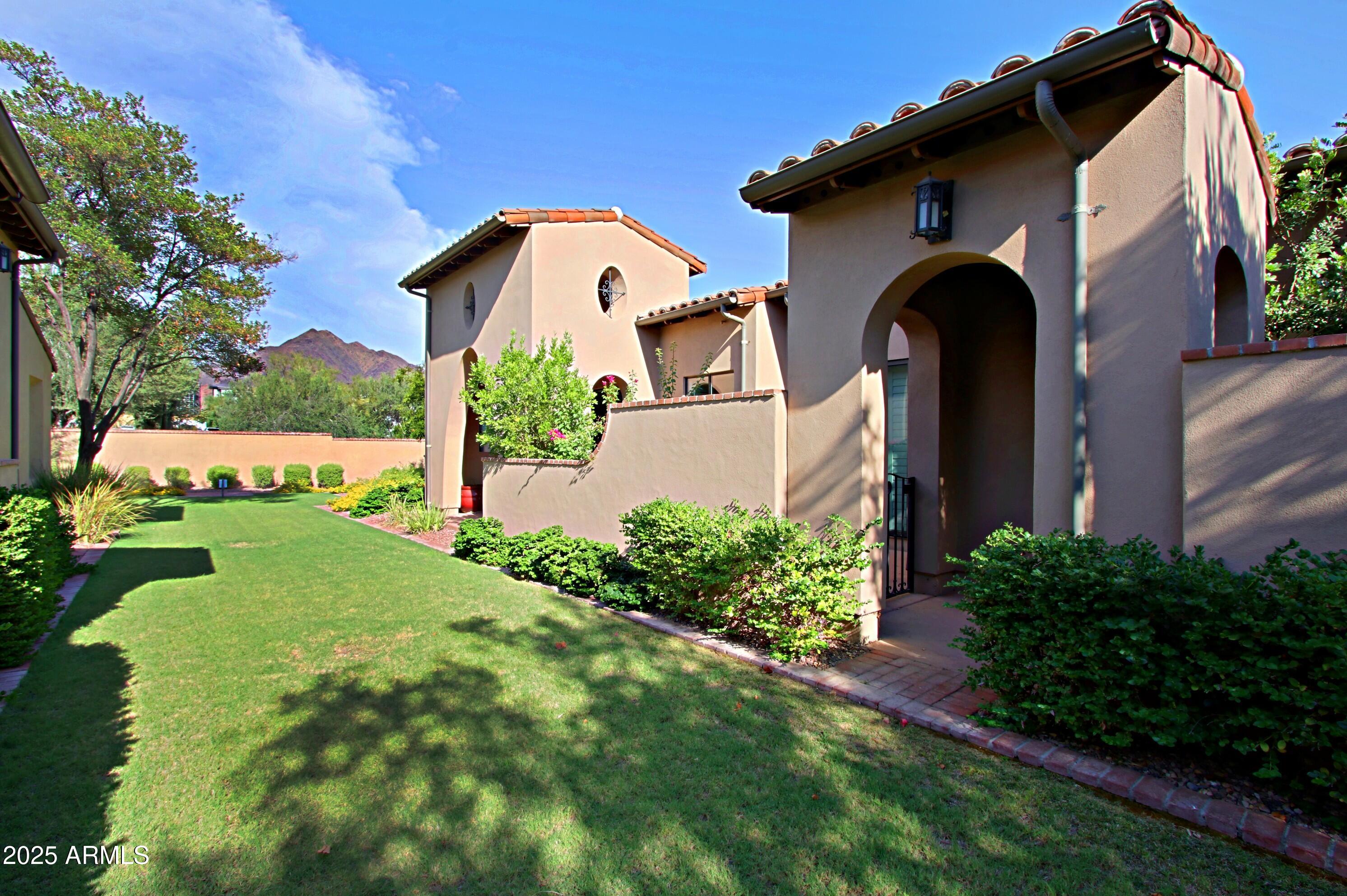 18650 North Thompson Peak Parkway, Unit 1052 Scottsdale, AZ 85255 - Photo 24 of 38 a front view of a house with garden